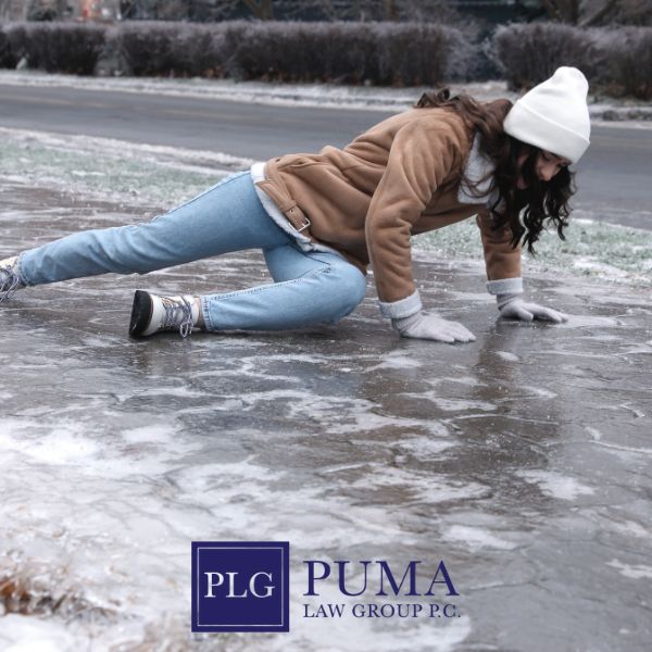 A woman in winter clothing slips and falls on an icy sidewalk. Puma Law Group P.C. logo appears at the bottom of the image.