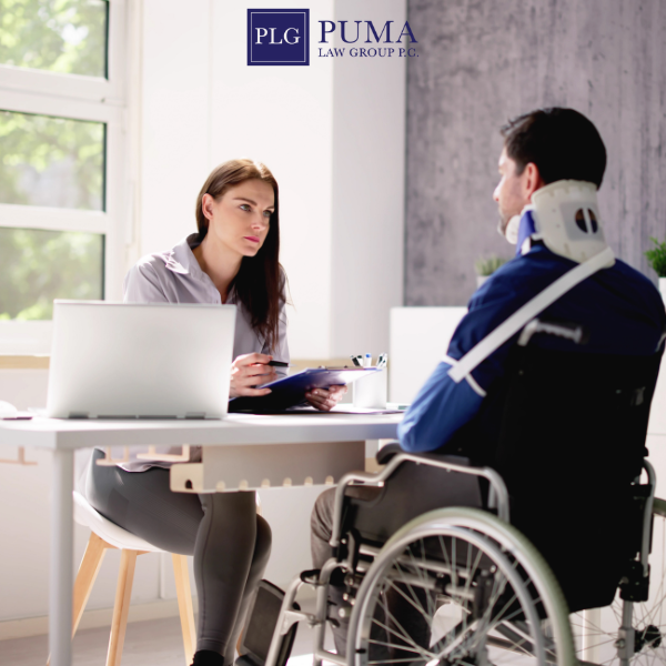 A woman interviews a man in a wheelchair with a neck brace and arm sling in an office; PLG Puma Law Group logo is visible on the wall.