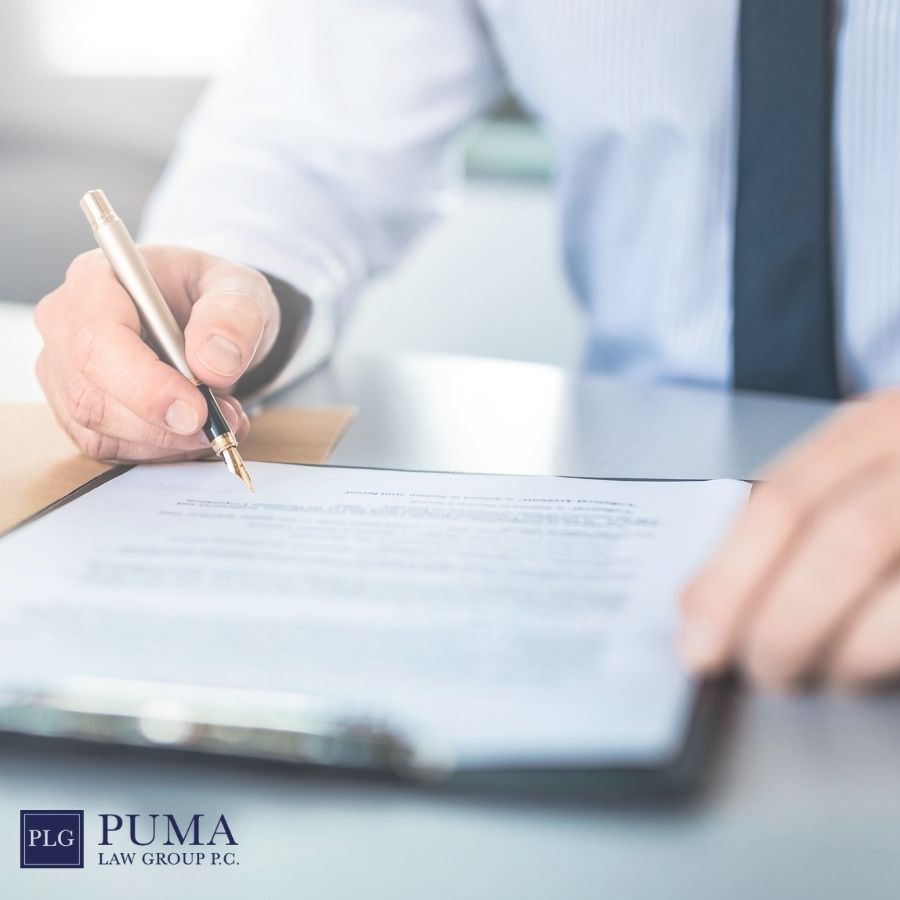 A person in business attire signs a document on a clipboard, while the Puma Law Group P.C. logo and "car accident lawyer in Holbrook" appear in the lower left corner. A person in business attire signs a document on a clipboard, while the Puma Law Group P.C. logo and "car accident lawyer in Holbrook" appear in the lower left corner.
