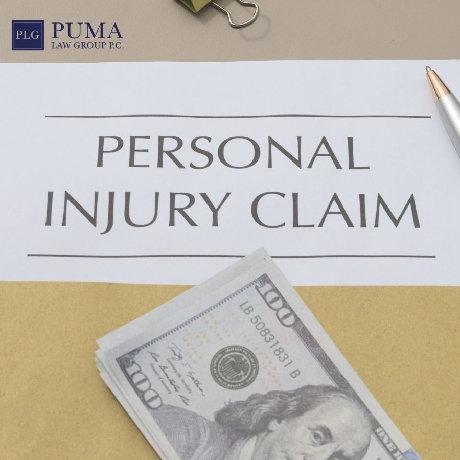 A document labeled “Personal Injury Claim” sits on a desk with a pen, a binder clip, and a stack of hundred-dollar bills nearby. A document labeled “Personal Injury Claim” sits on a desk with a pen, a binder clip, and a stack of hundred-dollar bills nearby.
